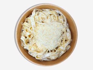 Fettuccine Alfredo prepared inside the Parmesan wheel, iconic fresh pasta from Pastasole NYC